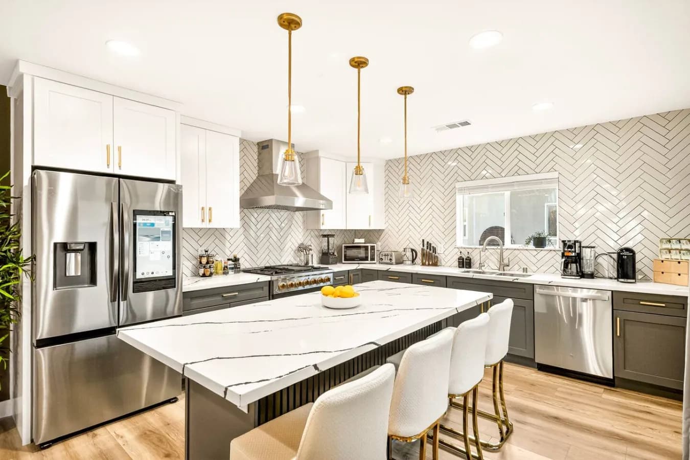 Kitchen with a marble island and four bar stools
