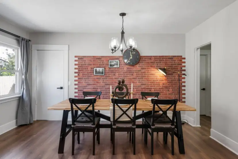 Dining room with a red brick feature wall