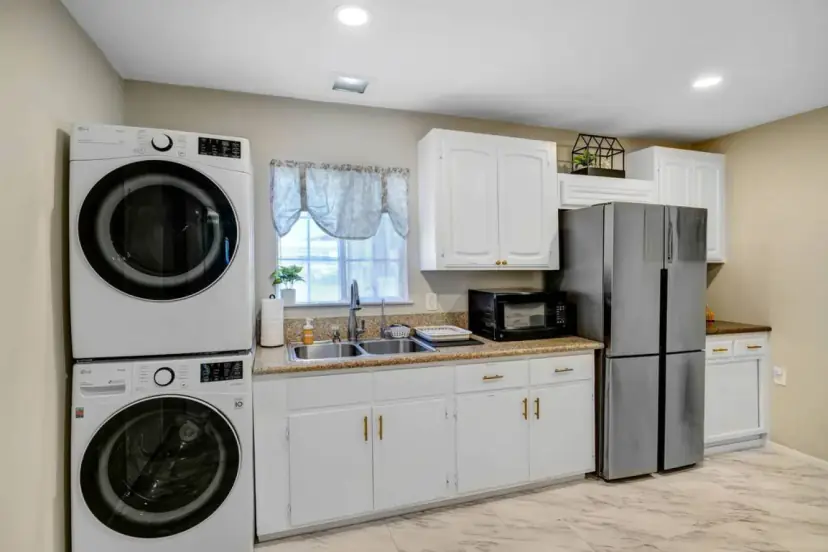 Kitchen with a stacked washer and dryer