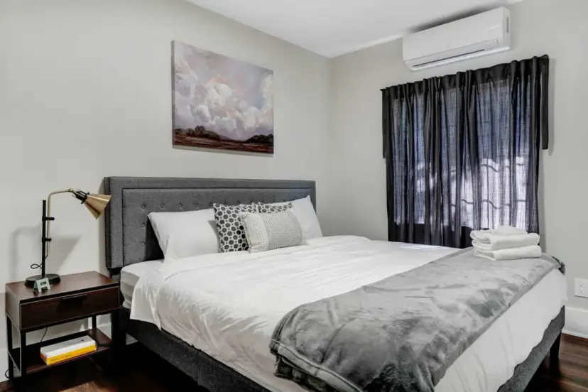 Bedroom with a king bed and dark curtains
