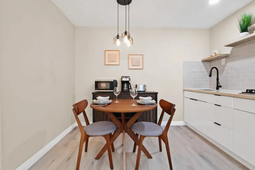 Round dining table under glass pendants