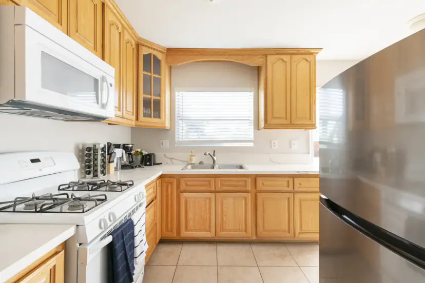 Oak kitchen with a white gas range and fridge