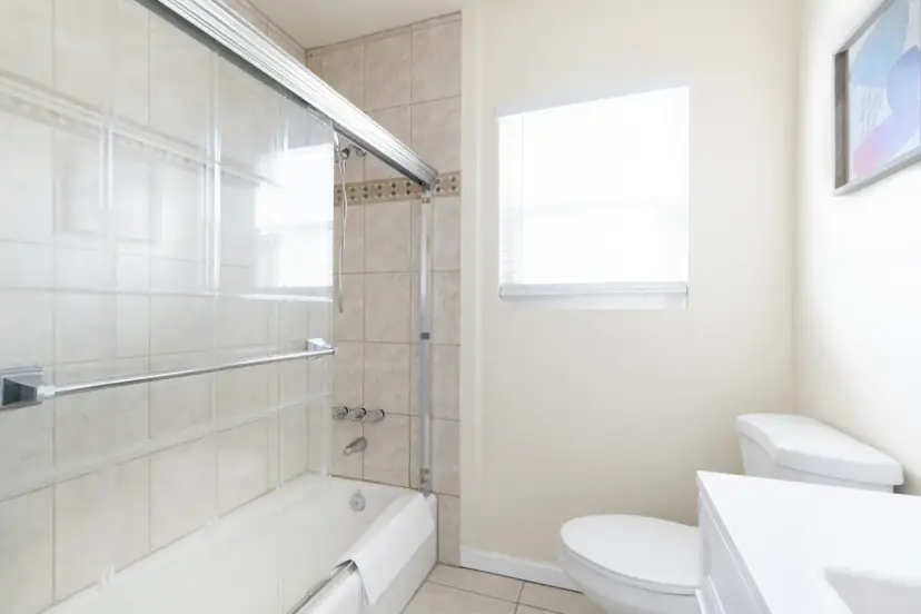 Bathroom with a tub and a sliding glass door