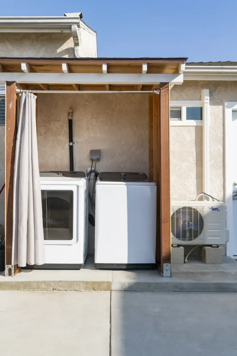 Covered outdoor laundry with a washer and dryer