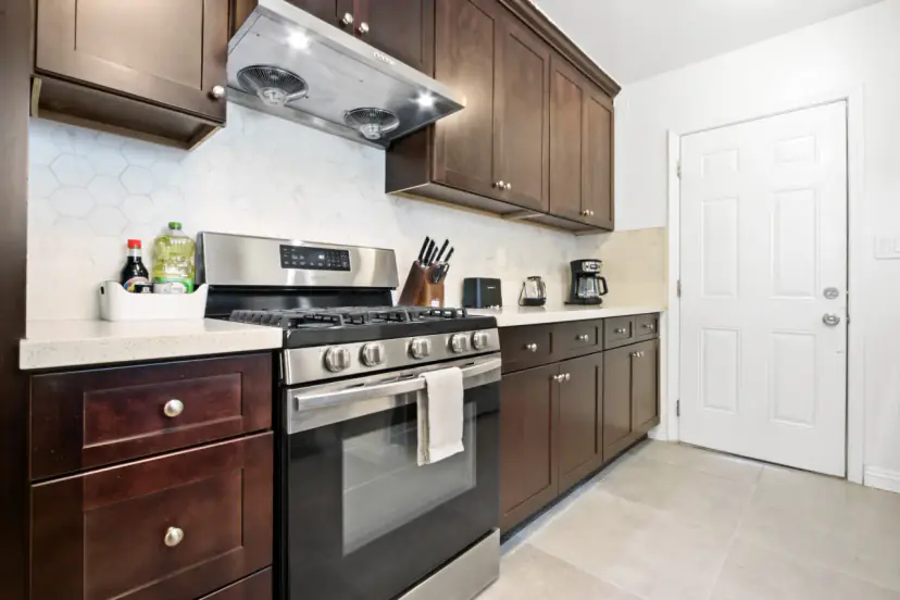 Kitchen with espresso cabinets and a gas range