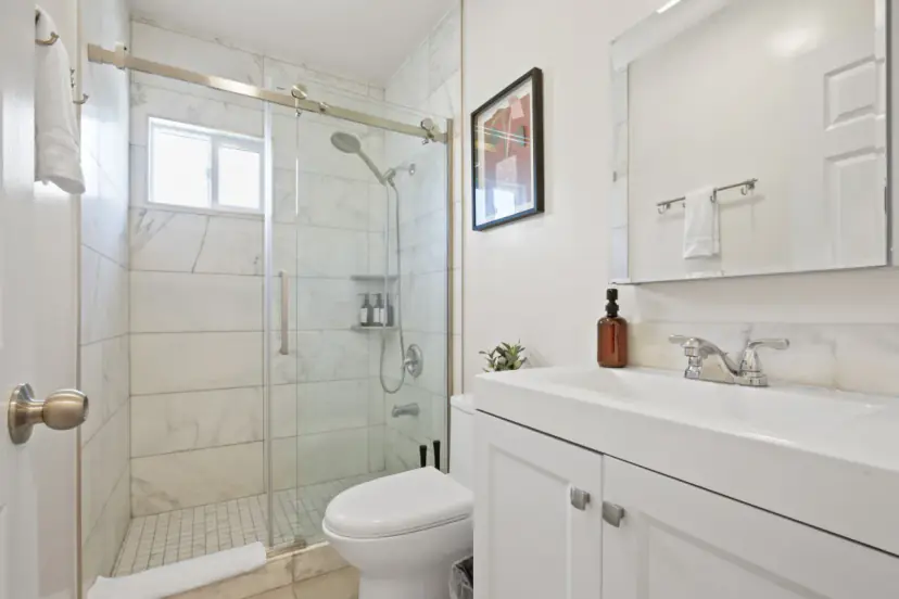Bathroom with a glass shower and a white vanity