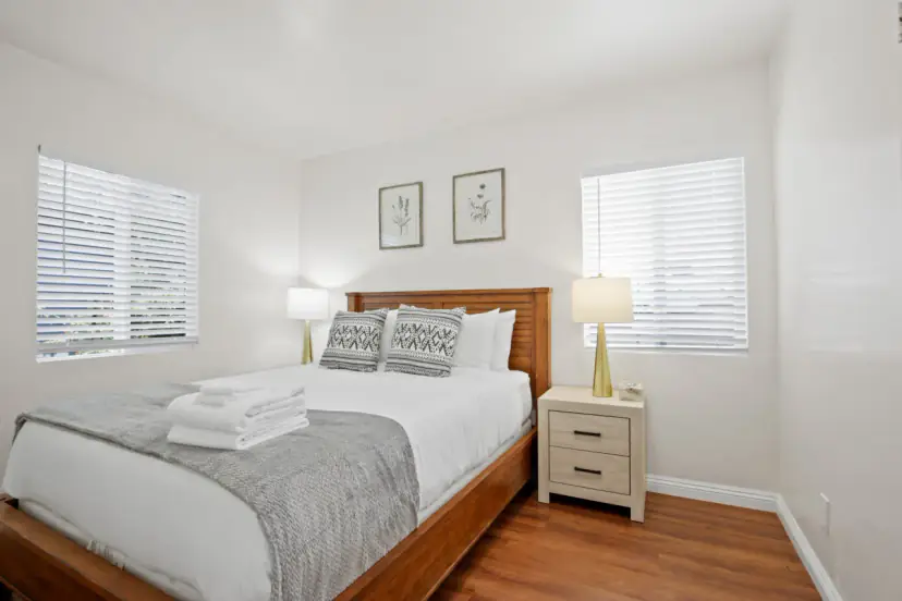 Bedroom with a wood bed and white bedding