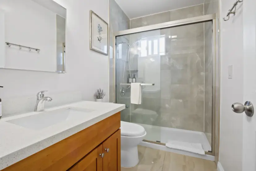 Bathroom with a glass shower and a wood vanity
