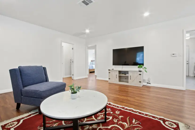 Living room with a blue armchair and a round coffee table