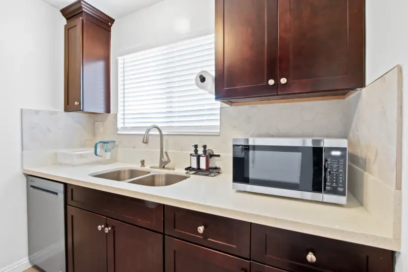 Kitchen with espresso cabinets and white quartz counters