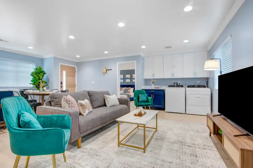 Living room with a grey sofa and teal chairs