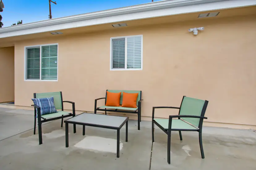 Patio loveseat and chairs by the wall