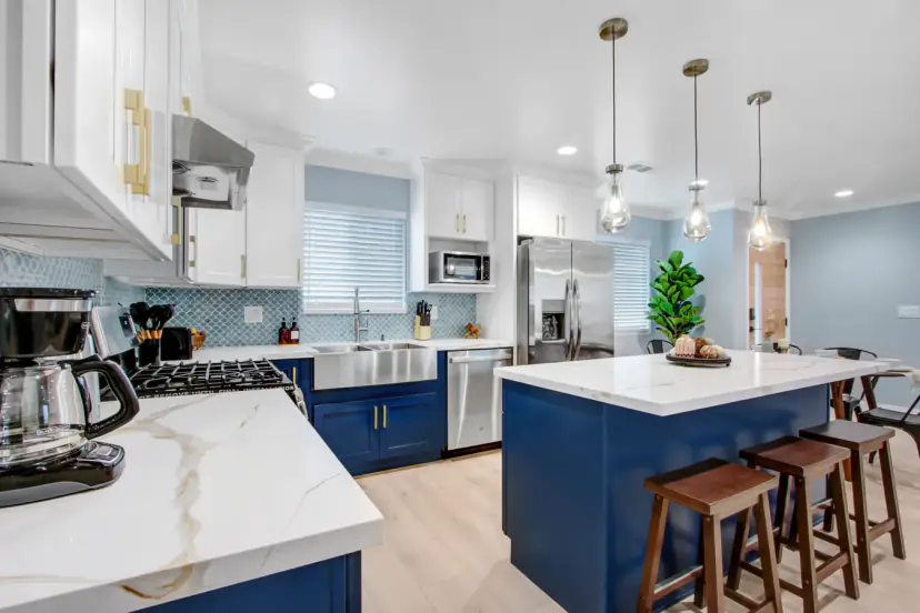 Kitchen island with wood stools and a gas range