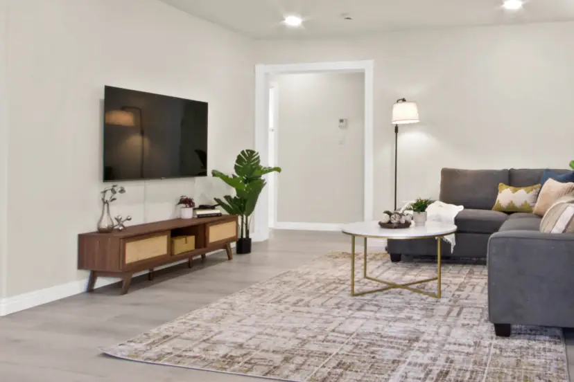 Living room with a wall TV and a grey sectional