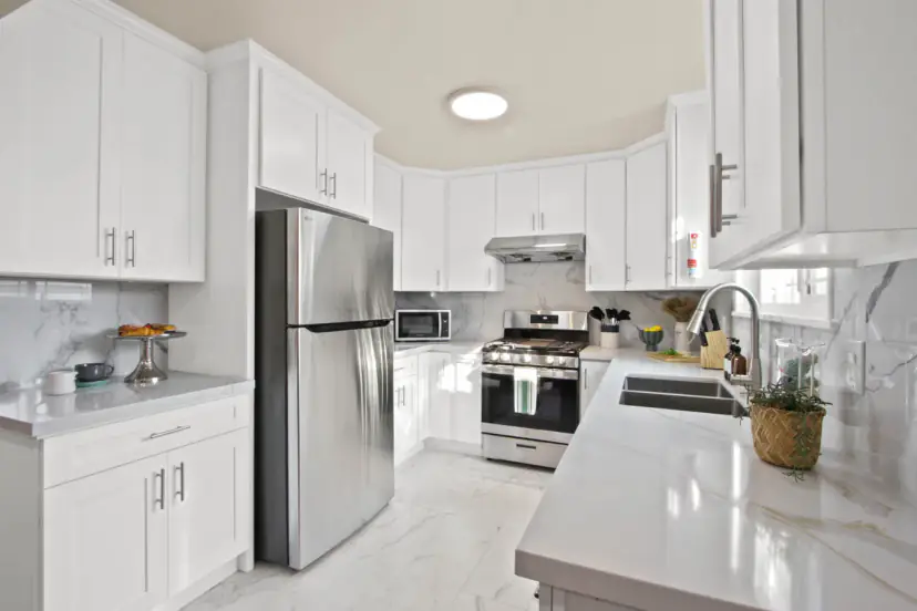 White shaker kitchen with a marble-look backsplash