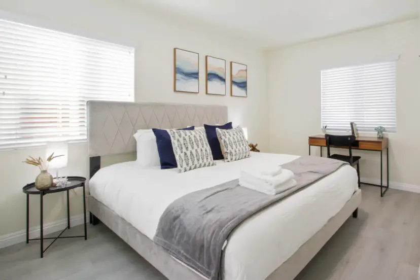 King bed with a diamond-tufted headboard and a desk