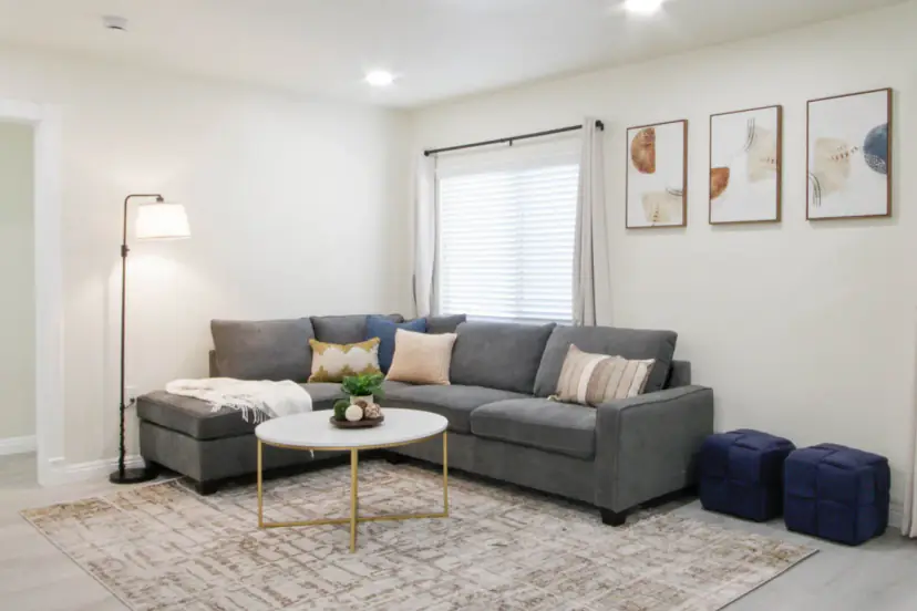 Grey sectional with a round coffee table