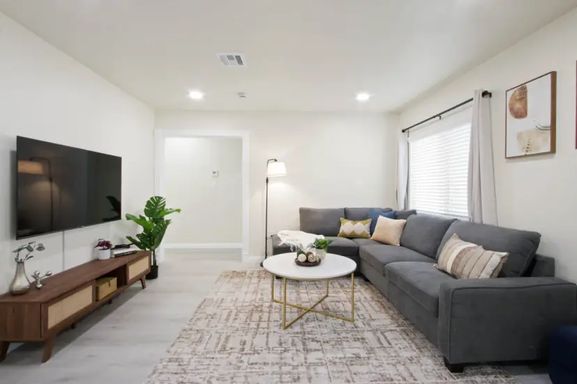 Long living room with a TV console and sectional