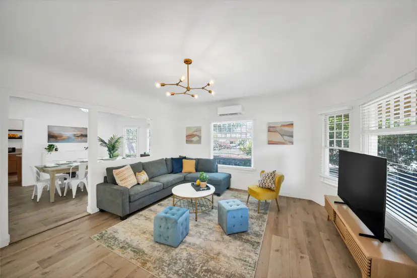 Living room with a sectional, ottomans and TV