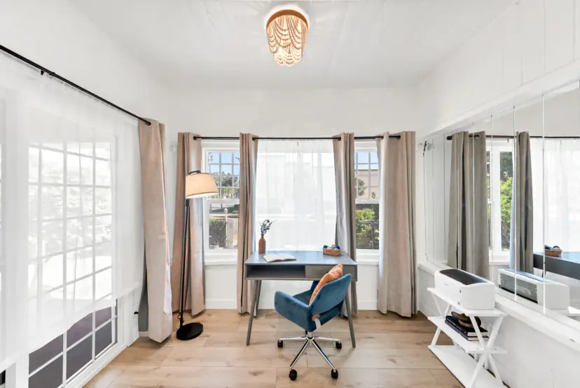 Sunroom office with a desk and printer