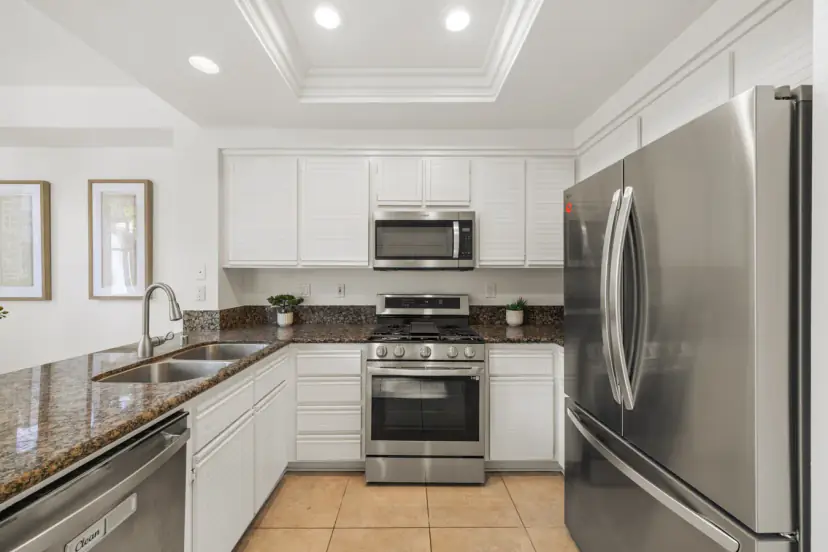 White kitchen with granite and stainless appliances