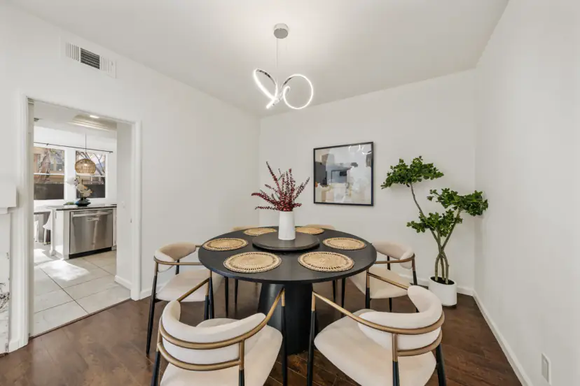 Round dining table with cream chairs and a pendant