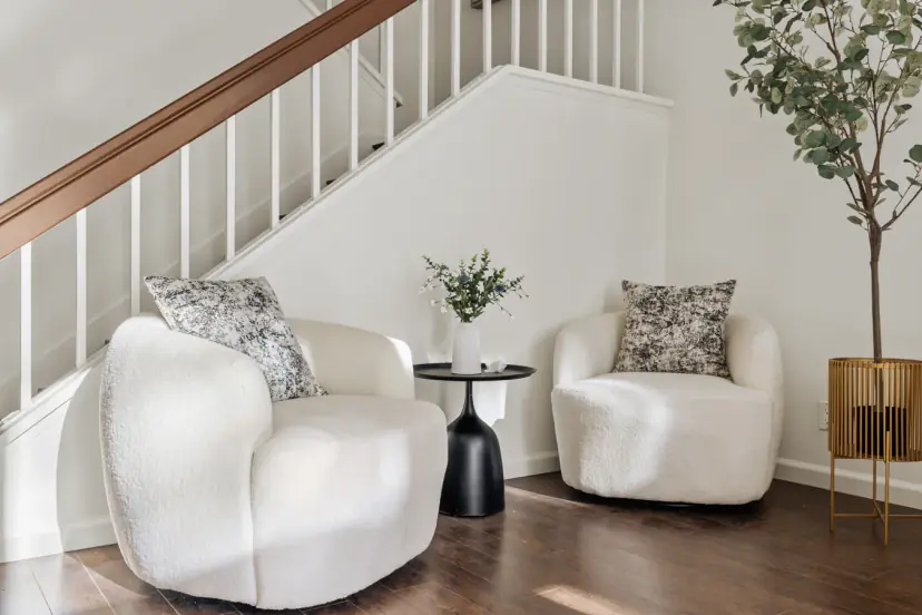Two boucle armchairs under the staircase
