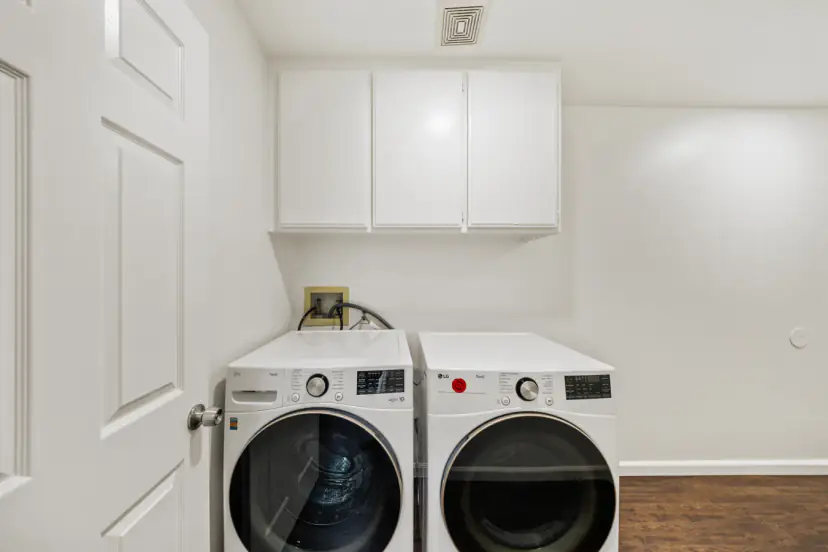 Laundry closet with a front-load washer and dryer