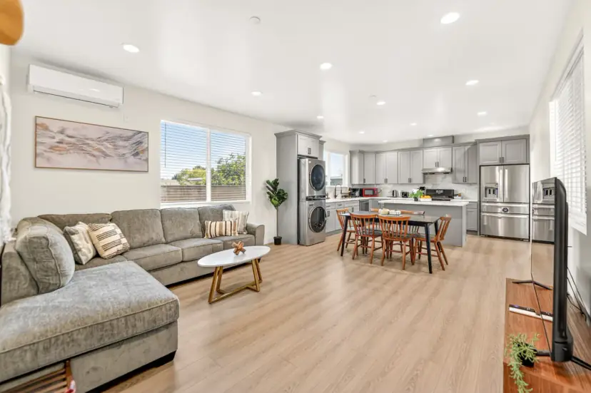 Open living room, dining table and kitchen with light oak-look floors