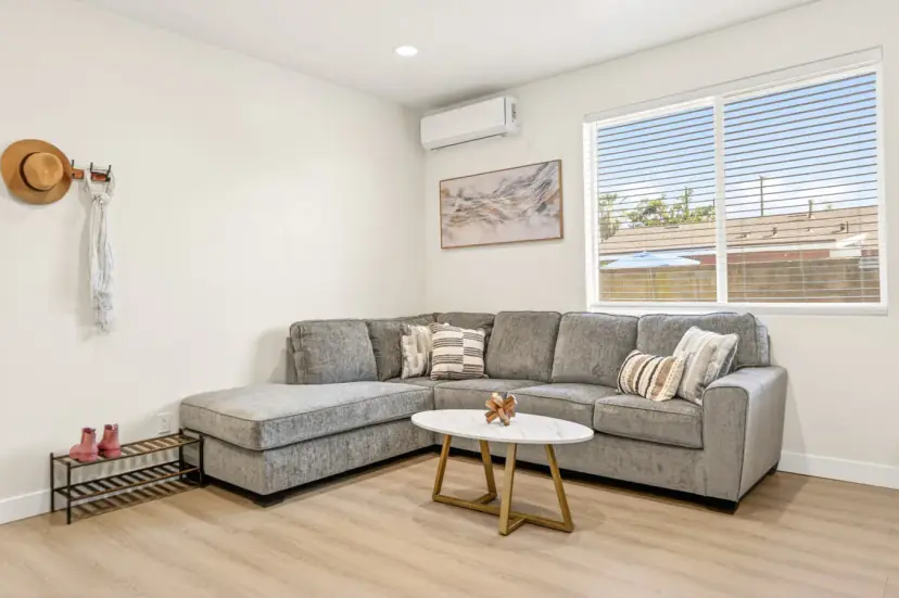 Living room with a grey sectional and a round coffee table