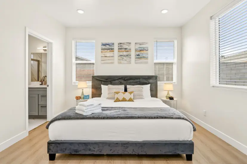 Bedroom with a king bed and the bathroom beyond