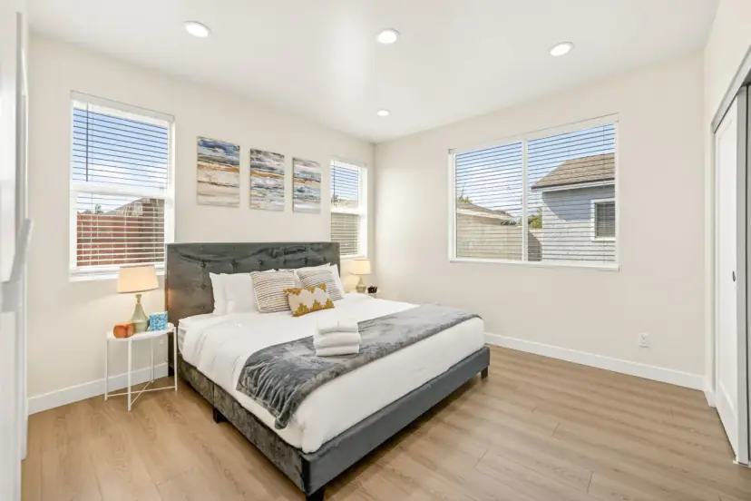 Bedroom with a queen bed and two windows