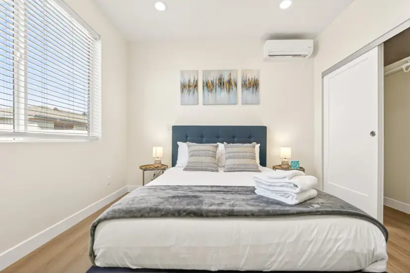 Bedroom with a navy headboard and a sliding closet
