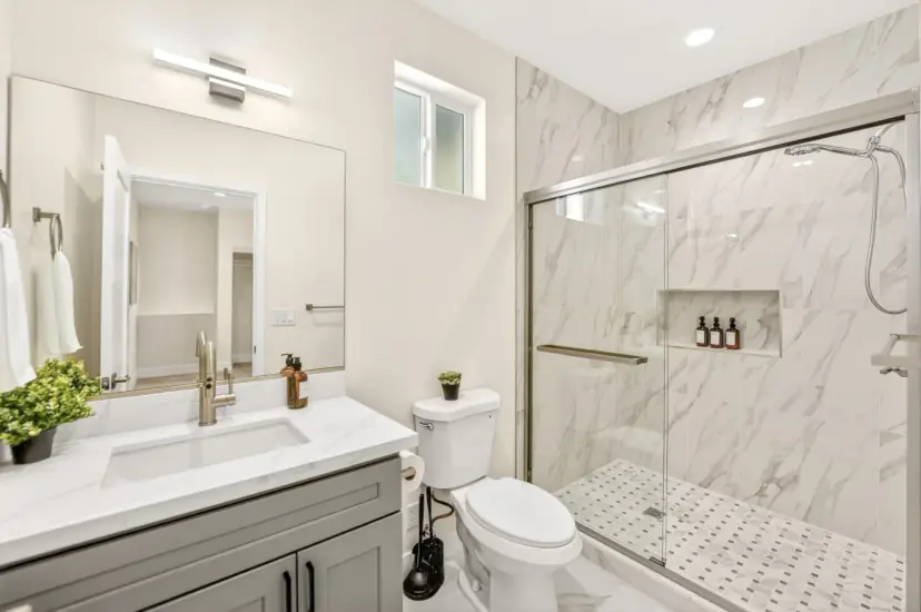 Bathroom with a marble-look walk-in shower