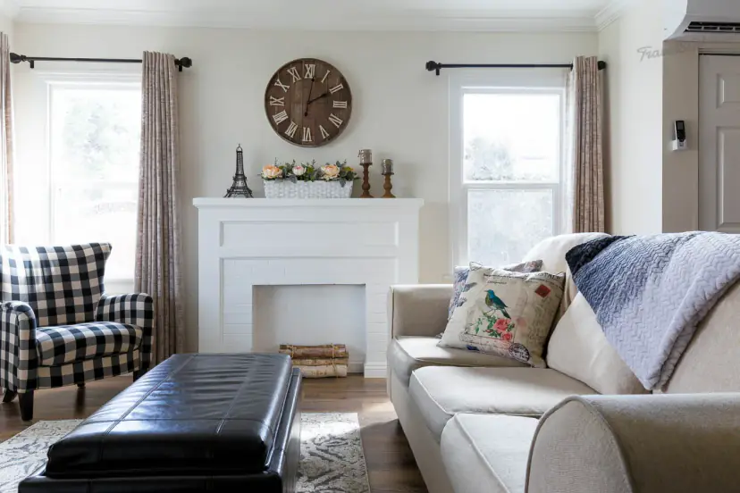 Living room with a white mantel, a buffalo-check armchair and a sofa