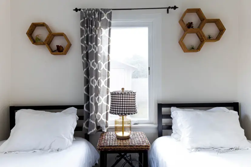 Two beds with hexagon wall shelves