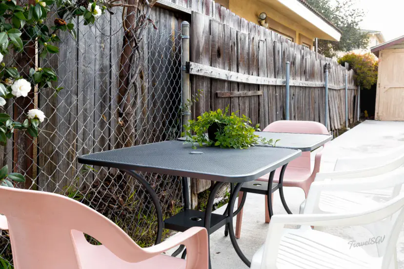 Side patio with tables and chairs