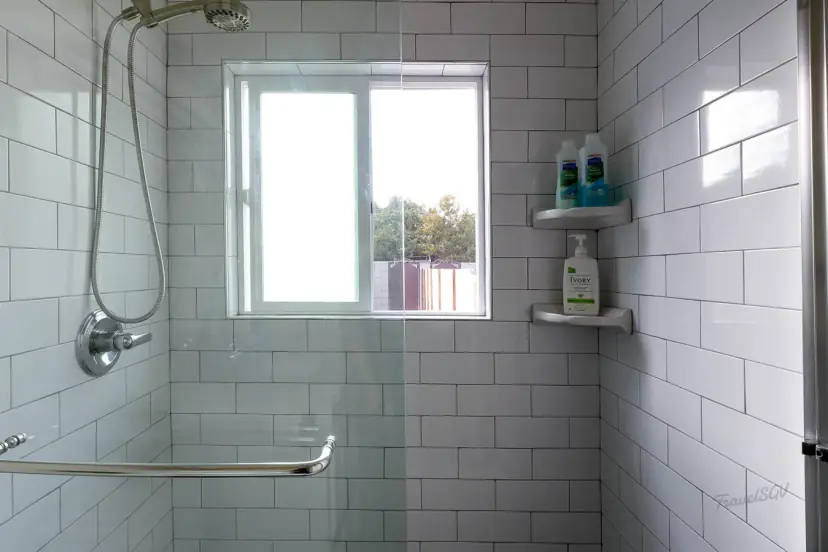 Subway-tiled walk-in shower with a window
