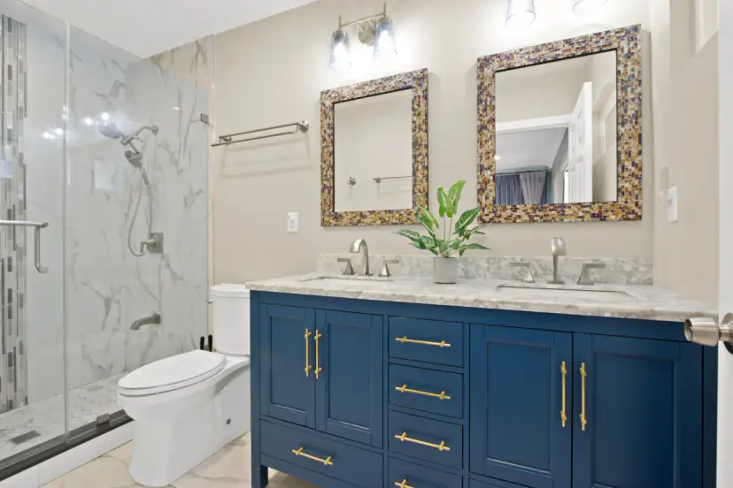 Bathroom with a navy double vanity and a glass shower