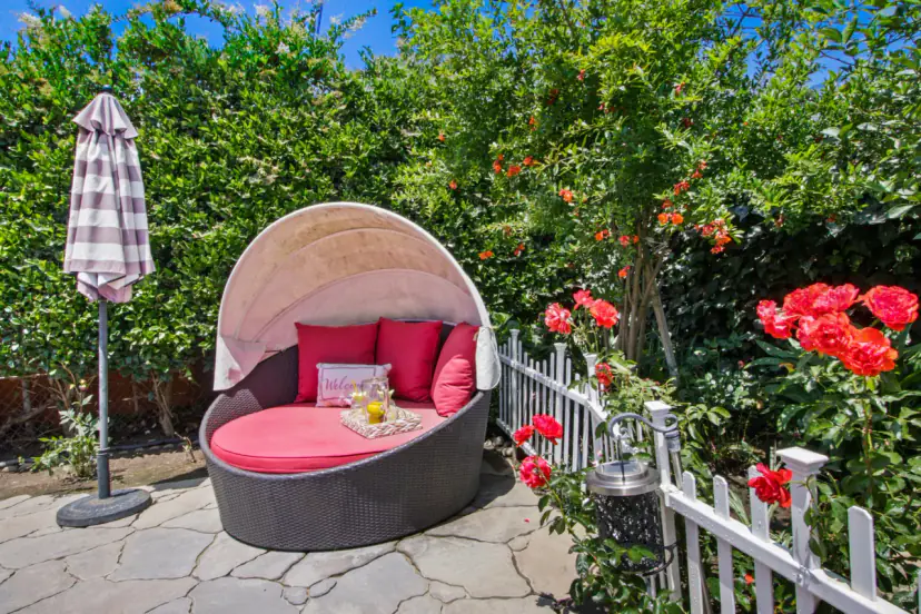 Canopy daybed among roses in the garden
