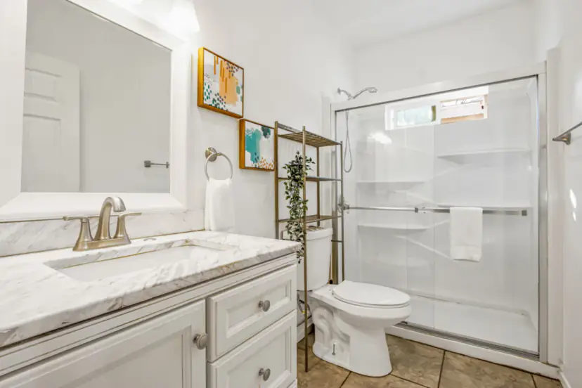 Bathroom with a white vanity and a shower stall