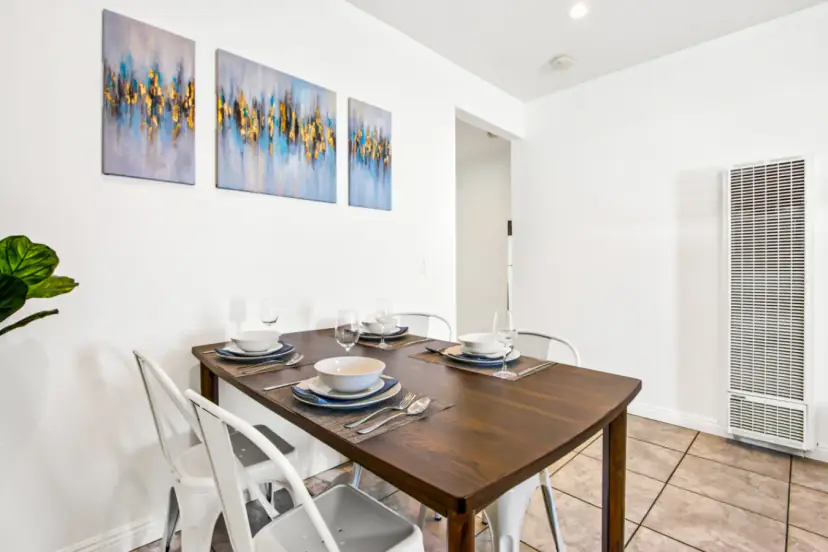 Dining table for four with white metal chairs