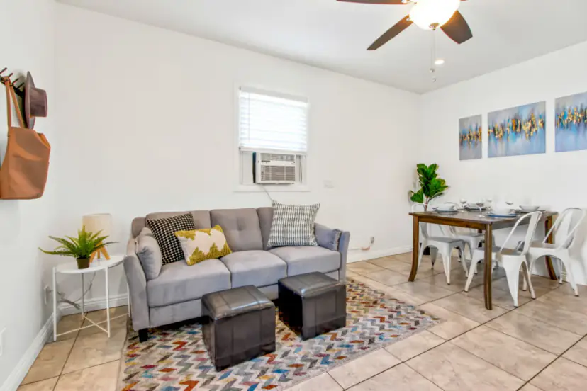 Living room with a grey sofa and ottomans