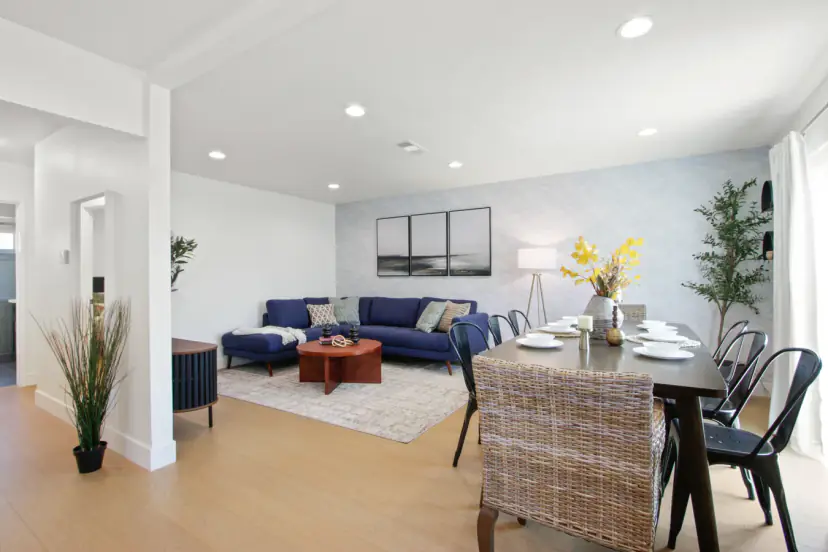 Living room with a navy sectional and a long dining table