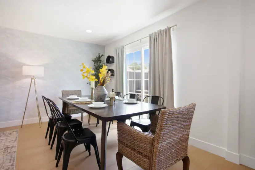 Dining table for eight with black metal and wicker chairs