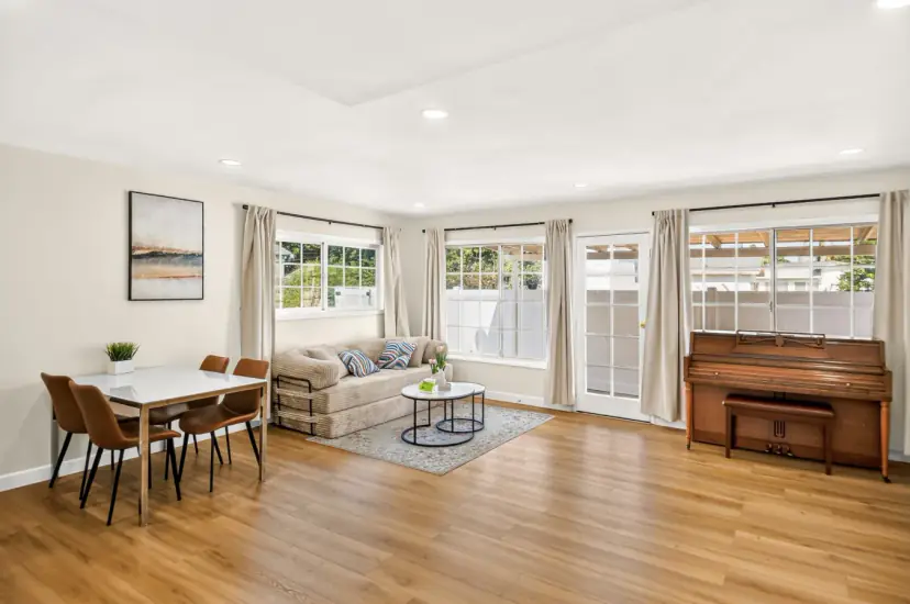 Open living and dining room with an upright piano