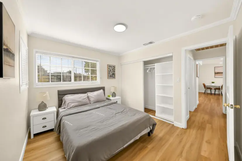 Bedroom with a queen bed and a closet