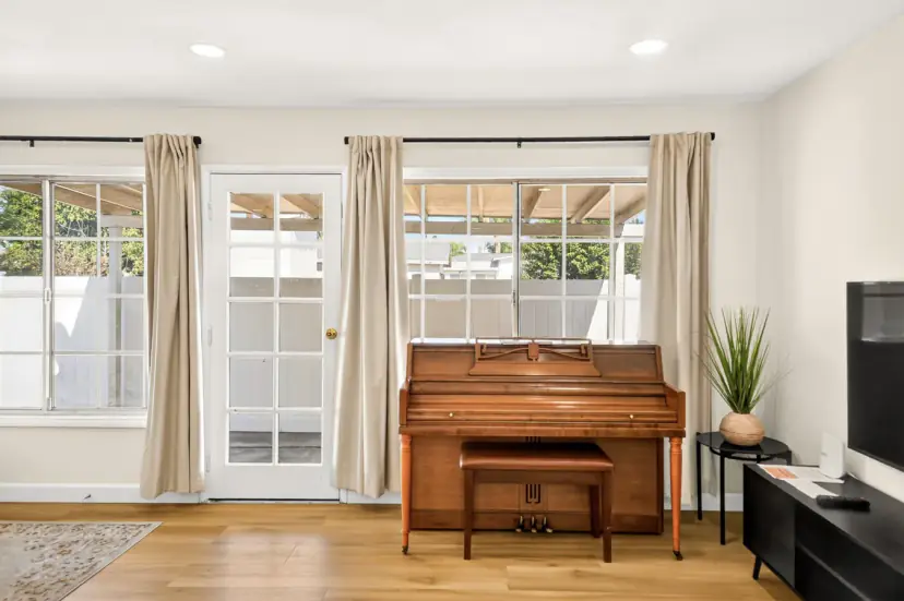 Upright piano by French doors