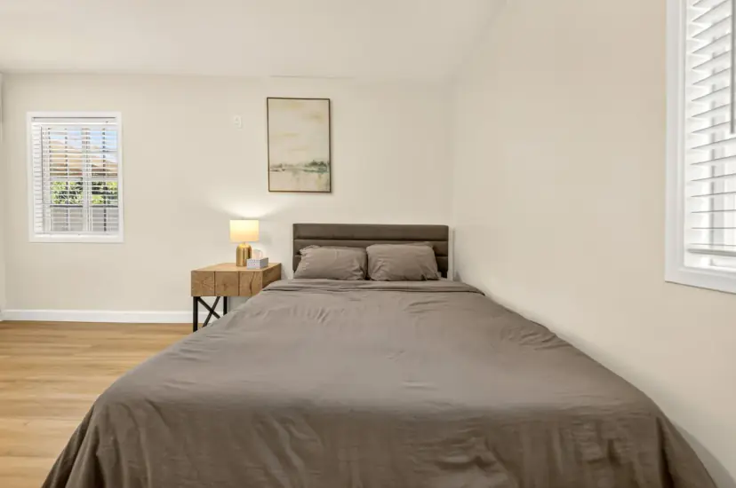 Bedroom with a queen bed and a window
