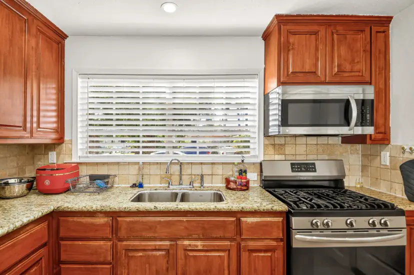 Kitchen with a stainless gas range and granite counters